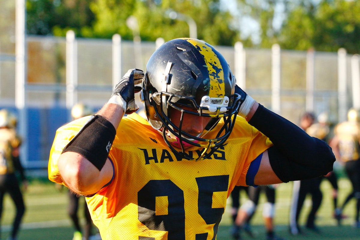Hawks Football Player Taking his Helmet off